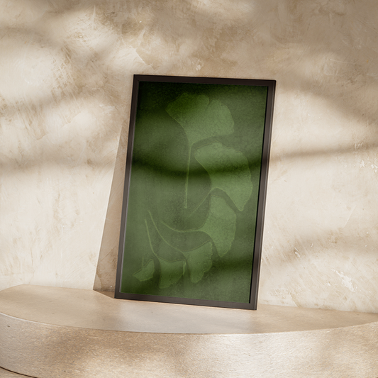 Framed abstract artwork on a pedestal against a textured wall.
