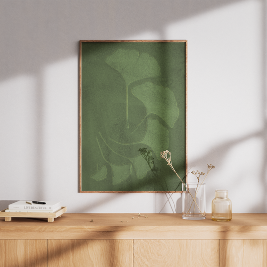 Green abstract art print on a wooden shelf with minimal decor