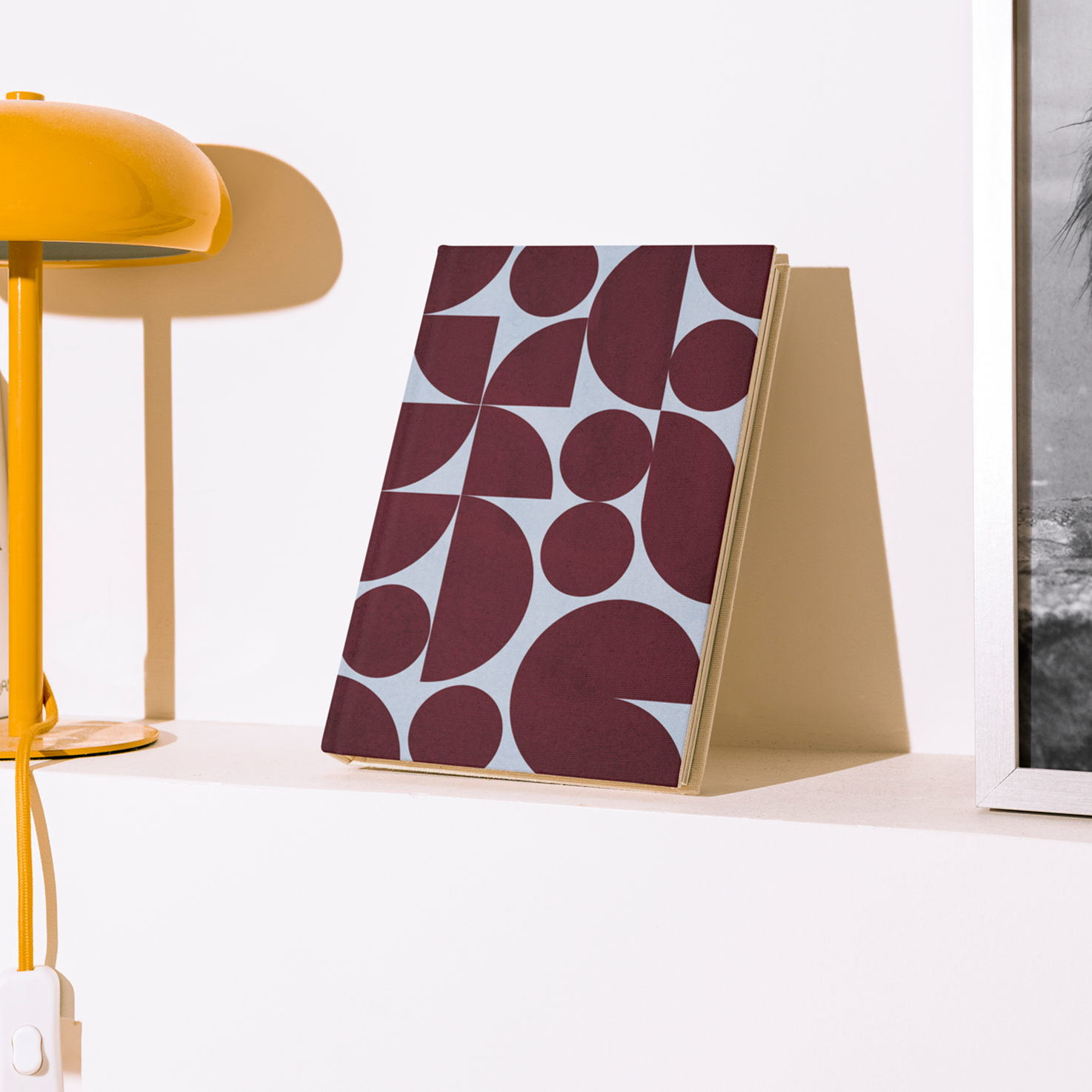 Yellow lamp and decorative items on a shelf against a white wall