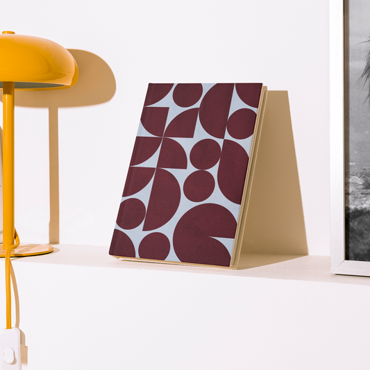 Yellow lamp and decorative items on a shelf against a white wall