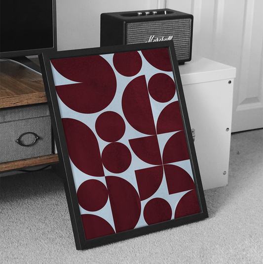 Framed abstract art with red and white pattern on a gray floor.